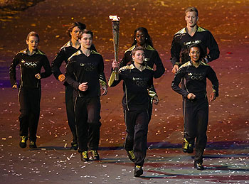 The seven British athlete representing Britain's hopes for the next Olympics run with the Olympic torch during the Opening Ceremony of the London Olympic Games on  Friday