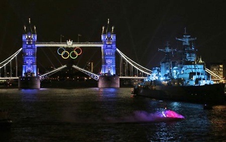 A speedboat, bottom right, carrying the Olympic Flame