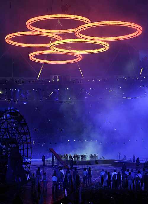 Illuminated Olympic rings hang over performing actors during the Opening Ceremony at the 2012 Summer Olympics