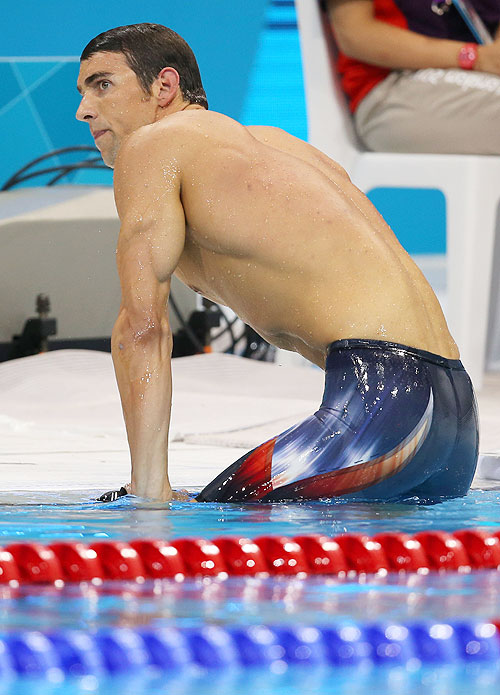 Michael Phelps of the United States climbs out of the pool after he finished fourth in the final of the Men's 400m Individual Medley