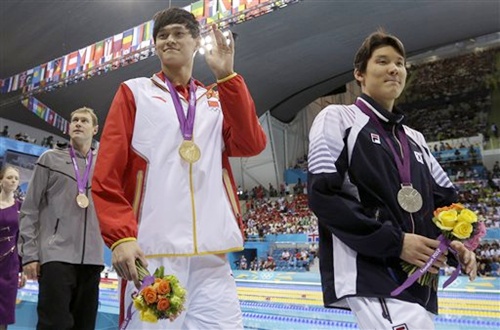 Gold medal winner China's Sun Yang waves with silver medal winner South Korea's Park Tae-hwan, right, and United States' Peter Vanderkaay