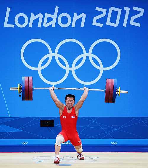 Yun Chol Om of DPR Korea celebrates breaking the Olympic Record in the Mens 56kg Group B weightlifting of the London 2012 Olympic Games
