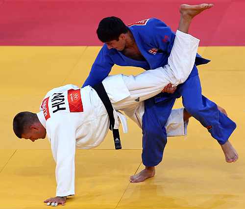 Lasha Shavdatuashvili of Georgia competes with Miklos Ungvari of Hungary for the gold medal in Men's -66 kg Judo of the London 2012 Olympic Games