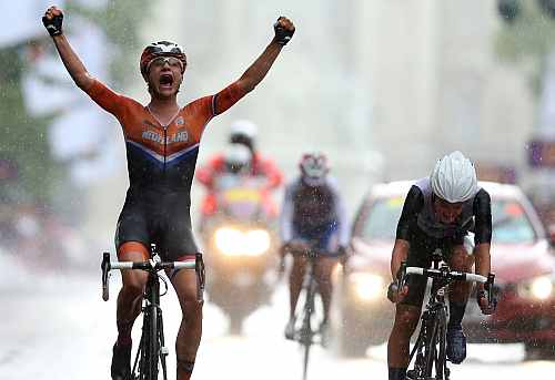 Marianne Vos of Netherlands (L) celebrates as she crosses the finish line ahead of Elizabeth Armitstead of Great Britain (R) to win the Women's Road Race Road Cycling