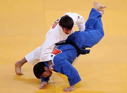 Mansur Isaev of Russia (white) competes for the gold medal with Misato Nakamura of Japan during the Men's 73 kg Judo
