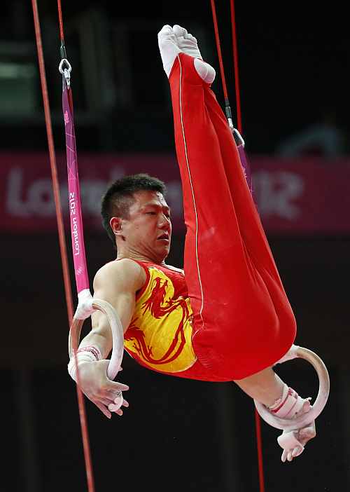 Chinese gymnast Chen Yibing performs on the rings during the Artistic Gymnastic men's team final