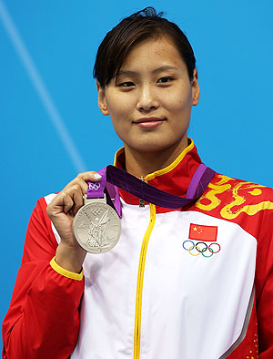 Silver medallist Ying Lu of China poses on the podium during the medal ceremony for the Women's 100m Butterfly final