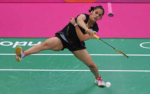 Saina Nehwal of India returns a shot against Lianne Tan of Belgium during their Women's singles Badminton match