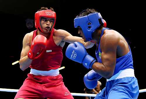 Sumit Sangwan of India (L) in action with Yamaguchi Falcao Florentino of Brazil during their Men's Heavy (81kg) Boxing