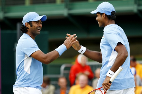 Vishnu Vardhan (right) of India taps hands with Leander Paes of India during the Men's Doubles match