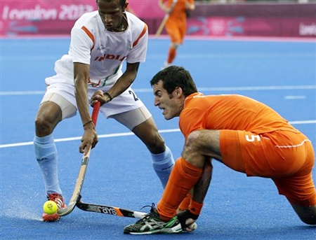 The Netherlands' Marcel Balkestein, right, and India's Sunil SV battle for ball possession