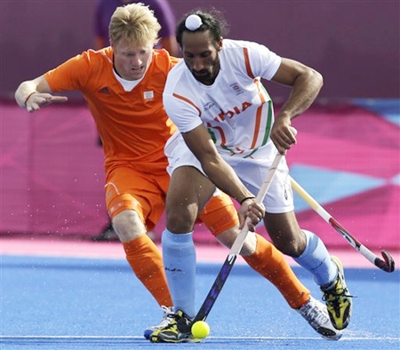 The Netherlands' Klaas Vermeulen, left, tries to steal the ball from India's Sardar Singh