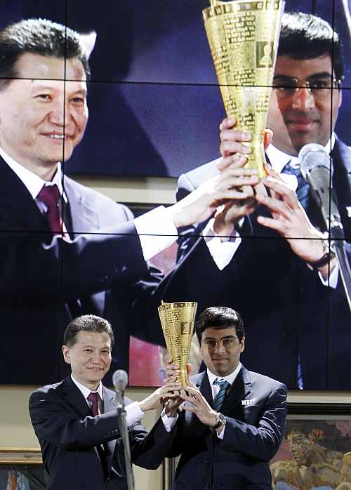World chess champion Viswanathan Anand of India receives a wreath from the World Chess Federation President Kirsan Ilyumzhinov
