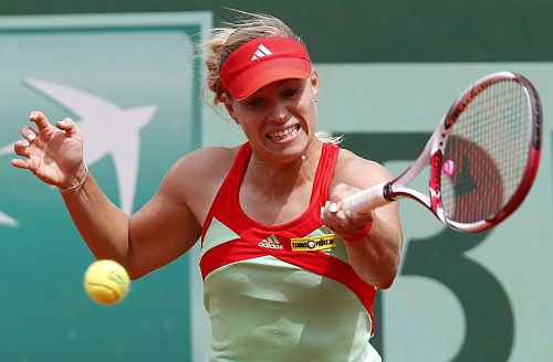 Angelique Kerber of Germany returns the ball to Petra Martic of Croatia during the French Open