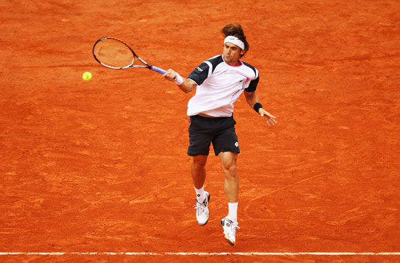 David Ferrer of Spain plays a forehand in his men's singles fourth round match against Marcel Granollers of Spain