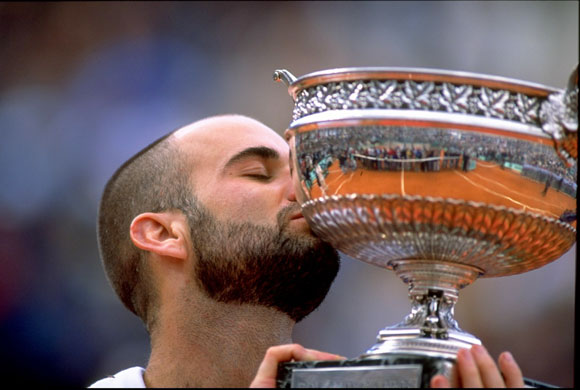 Andre Agassi kisses the trophy after victory in the 1999 French Open