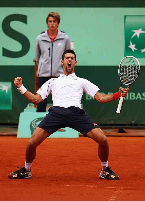 Novak Djokovic of Serbia celebrates victory in his men's singles quarter final match against Jo-Wilfried Tsonga of France