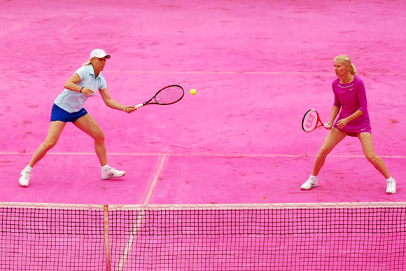 Martina Navratilova (L) of USA and Jana Novotna of Czech Republic play on a pink clay court