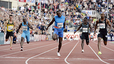 Usain Bolt of Jamaica (centre) crosses the line to pip Asafa Powell (right) and win the men's 100m race during the Diamond League athletics competition at the Bislett Stadium in Oslo on Thursday