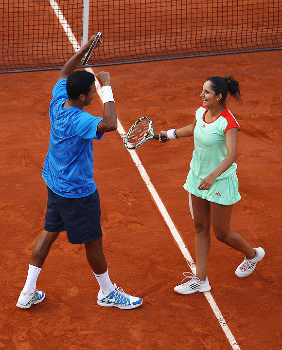 Sania Mirza and Mahesh Bhupathi celebrate after defeating Klaudia Jans-Ignacik of Poland and Santiago Gonzalez of Mexico in the French Open mixed doubles final