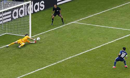 Poland's goalkeeper Tyton saves a penalty taken by Greece's Karagounis