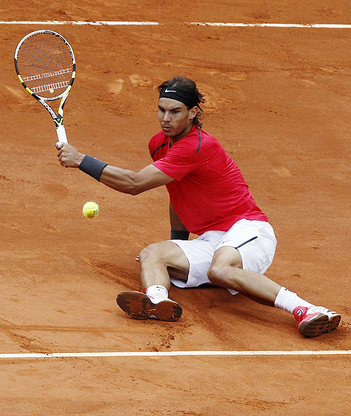 Rafael Nadal falls as he returns against David Ferrer