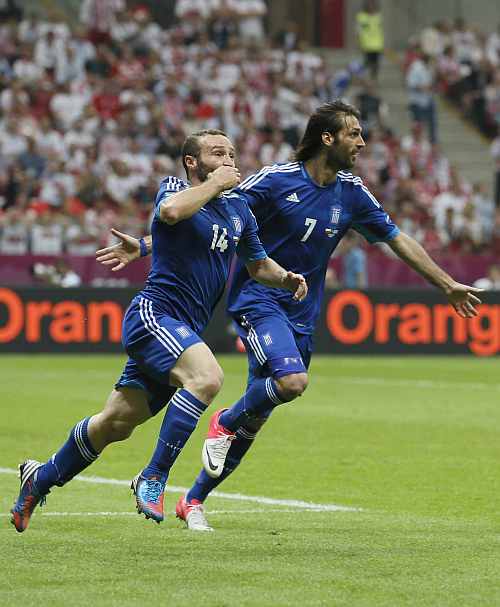 Greece's Dimitris Salpingidis celebrates with his team mate Giorgos Samaras after scoring againist Poland
