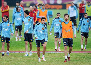 The Spanish national team make their way out of the field after a training session