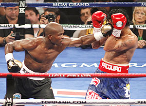 Timothy Bradley Jr. (left) connects on WBO welterweight champion Manny Pacquiao
