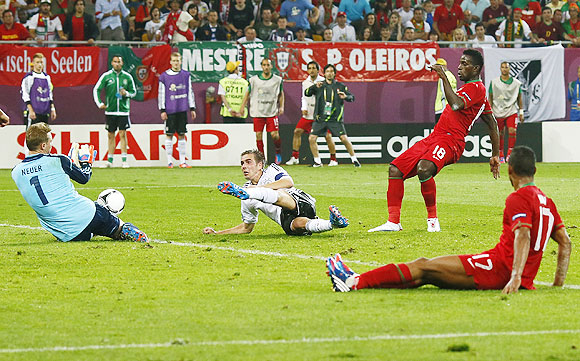 Portugal's Nani and Varela react as Germany's goalkeeper Neuer and Lahm make a save