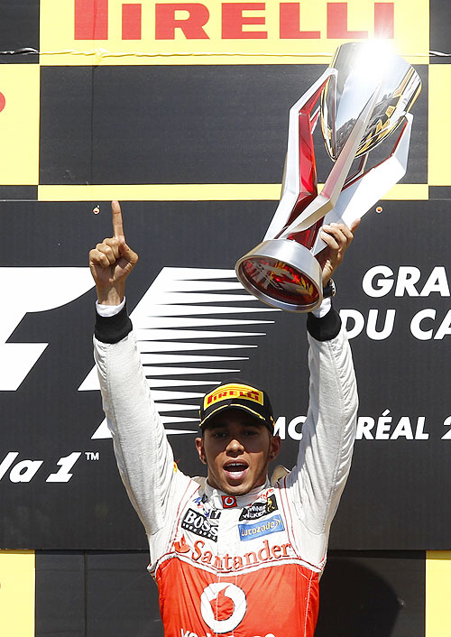McLaren's Lewis Hamilton lofts the trophy after winning the Canadian Grand Prix