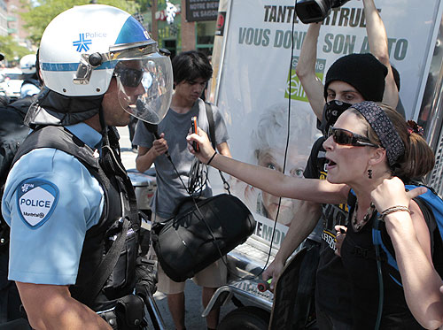 A protester confronts police during demonstrations aimed to disrupt the Canadian GP