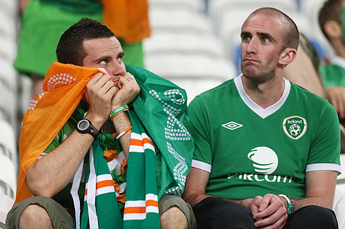 Ireland fans sit dejected in the stands after their team's defeat to Croatia