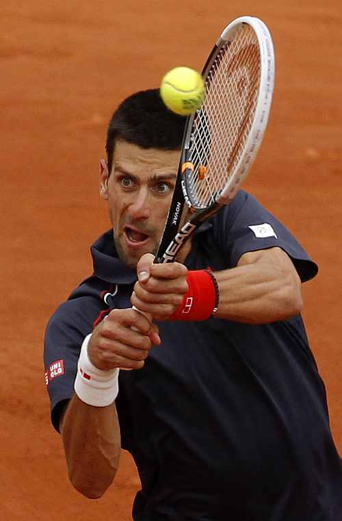 Novak Djokovic of Serbia returns the ball to Rafael Nadal of Spain during their men's singles final match at the French Open