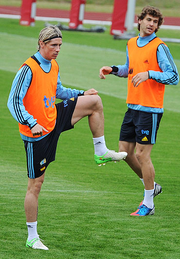 Fernando Torres (left) and teammate Fernando Llorente go through the grind at a training session