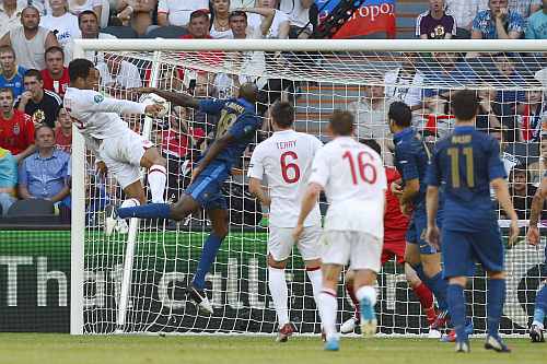 England's Joleon Lescott (L) scores past France's Alou Diarra during their Group D Euro 2012 soccer match at the Donbass Arena in Donetsk