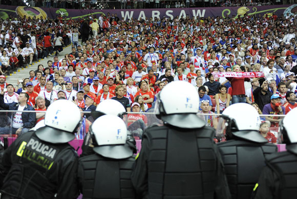 Polish riot police stand guard after the Group A Euro 2012 soccer match between Poland and Russia at the National stadium in Warsaw