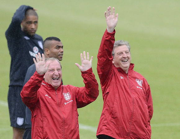 England soccer coach Roy Hodgson (R) and assistant Ray Lewington gesture during a training session at the Hutnik stadium in Krakow
