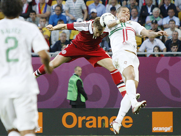 Denmark's Nicklas Bendtner (left) scores a goal past Portugal's Pepe
