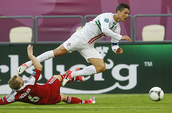Portugal's Cristiano Ronaldo is fouled by Denmark's Lars Jacobsen
