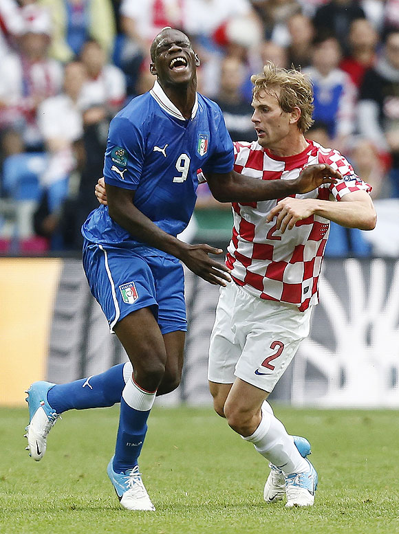 Italy's Mario Balotelli (left) grimaces as he is challenged by Croatia's Ivan Strinic