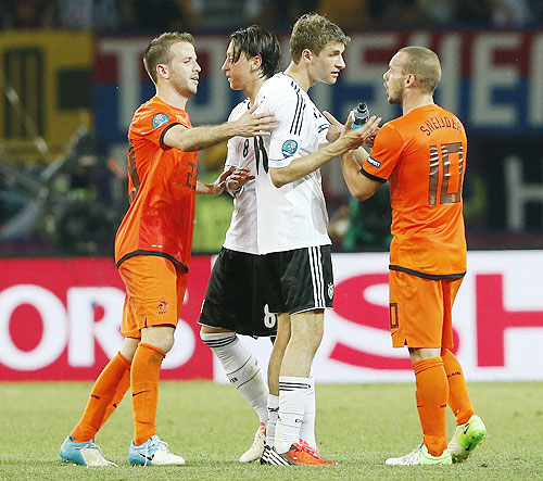 (From left) Netherlands' Rafael van der Vaart, Germany's Mesut Oezil, Thomas Mueller and Netherlands' Wesley Sneijder speak after their Euro match