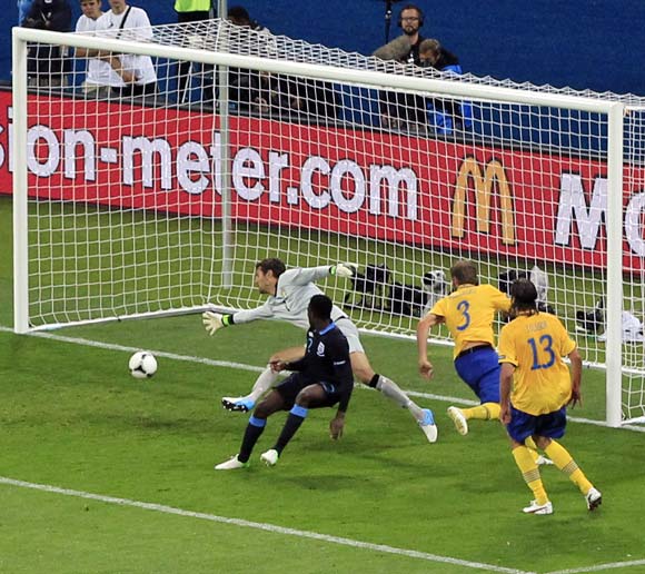 Danny Welbeck scores the third goal for England past Sweden's goalkeeper Andreas Isaksson