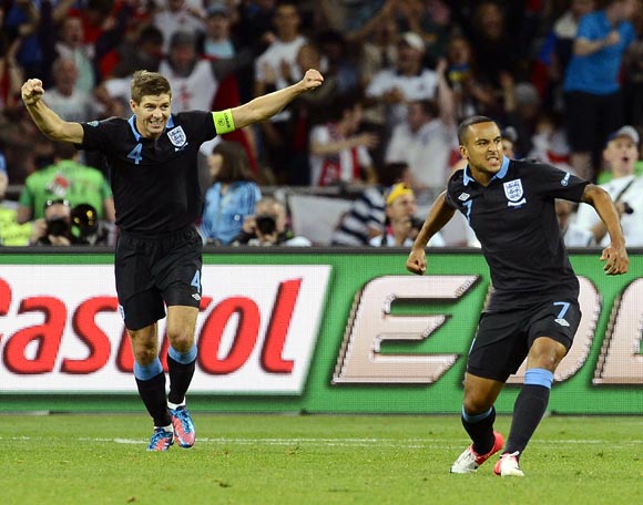Theo Walcott (right) celebrates with Steven Gerrard