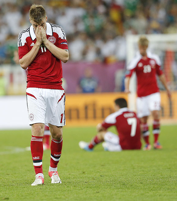 Denmark's Nicklas Bendtner (left) and teammates wear a sullen look after their loss to Germany