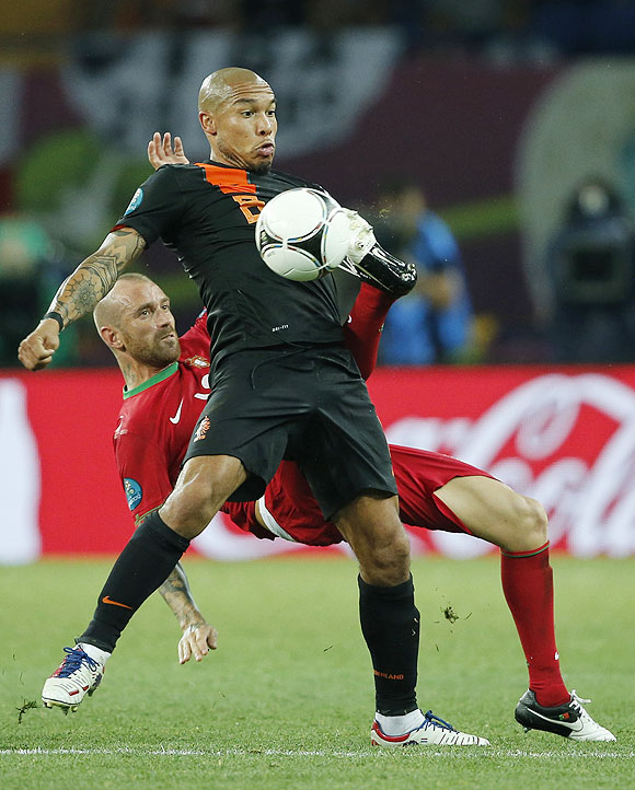 Portugal's Raul Meireles (left) and Netherlands' Nigel de Jong vie for possession