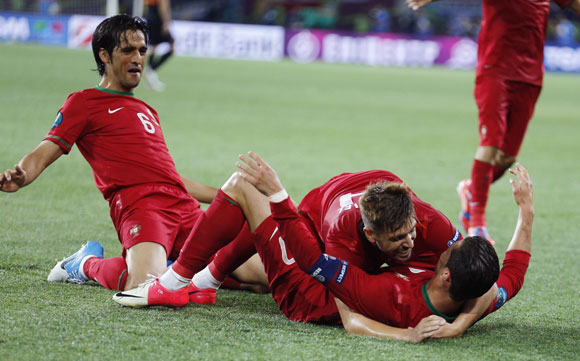 Portugal's players celebrate a goal against Netherlands during their Group B match at Metalist stadium in Kharkiv