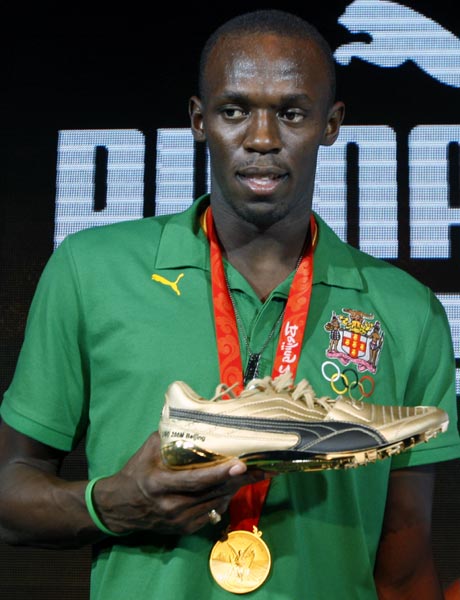 Usain Bolt shows his Puma shoes
