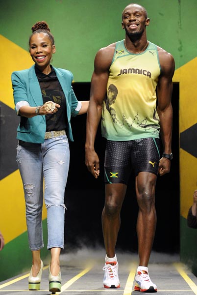 Jamaican sprinter Usain Bolt models the Jamaican team's kit for the London 2012 Olympic Games, designed by Cedella Marley (left)