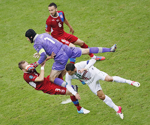 Portugal's Cristiano Ronaldo (centre) battles for the ball with Czech Republic's Tomas Sivok (right), Michal Kadlec (left) and goalkeeper Petr Cech